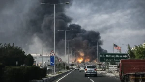 Blasts Reported in Dubai, Doha and Manama as Iran Targets US Assets Thick black smoke rising in a Gulf city as vehicles drive along a highway following a reported strike targeting US-linked assets
